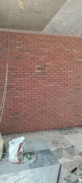Interior red brick wall under construction