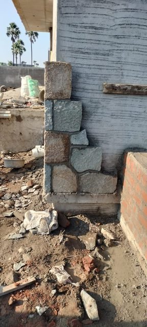 Grey stone cladding on a building corner